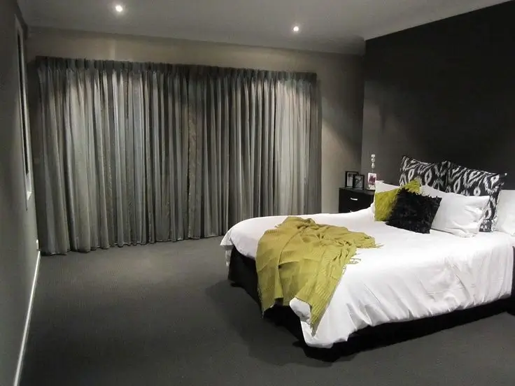 Cozy bedroom with dark blackout curtains for a restful atmosphere